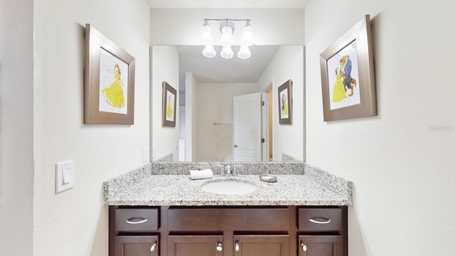 bathroom with vanity and an inviting chandelier