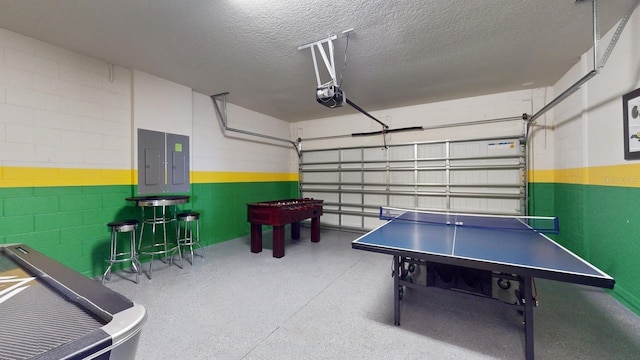 game room with a textured ceiling