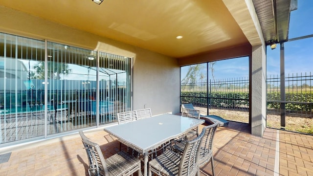 sunroom / solarium featuring outdoor dining space