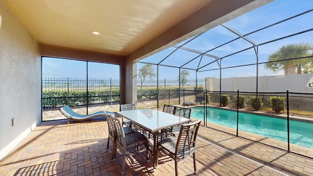 view of pool featuring a patio and glass enclosure