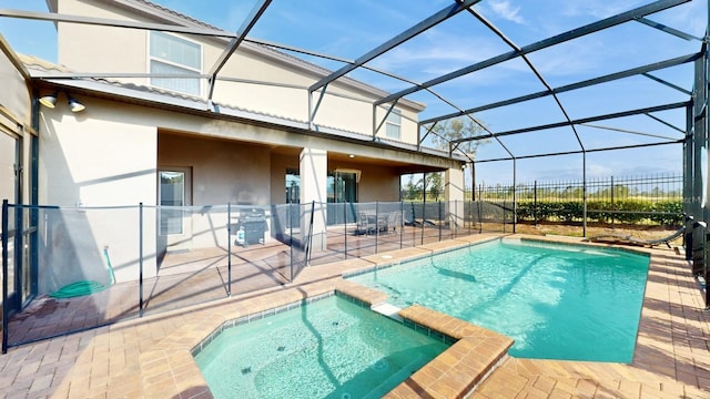 view of pool featuring glass enclosure, an in ground hot tub, a patio area, and area for grilling