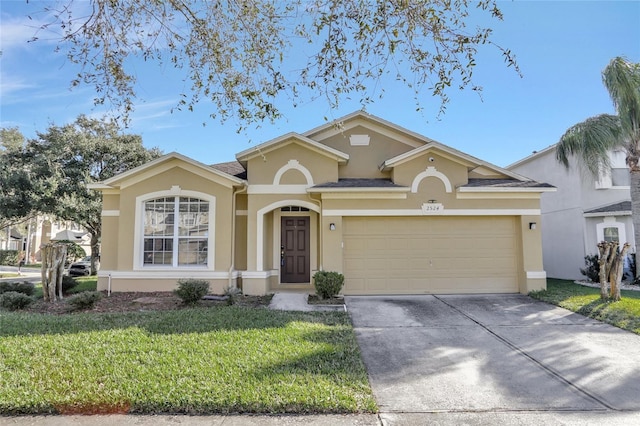 view of front of home with a front yard and a garage