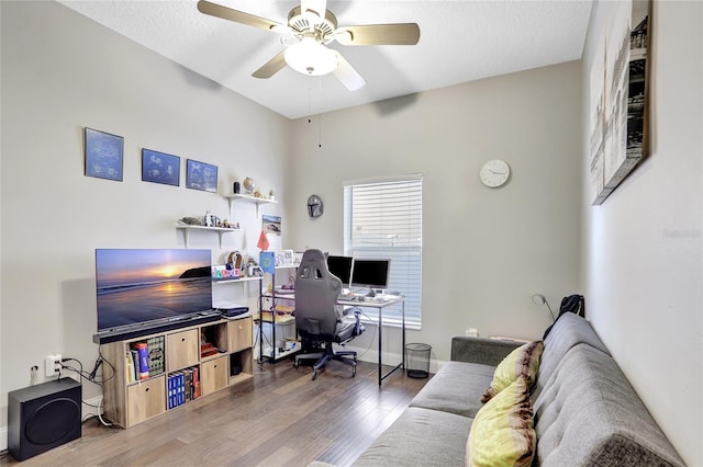 home office with ceiling fan, a textured ceiling, and hardwood / wood-style flooring