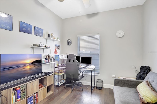 home office with ceiling fan and dark hardwood / wood-style flooring