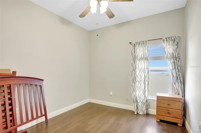 unfurnished bedroom with ceiling fan and dark hardwood / wood-style flooring