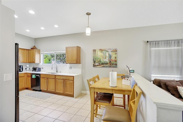 kitchen with sink, black dishwasher, kitchen peninsula, pendant lighting, and light tile patterned flooring