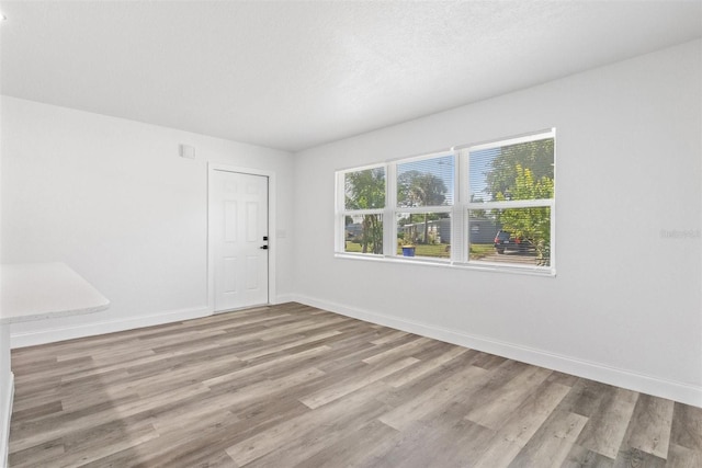 unfurnished room featuring light hardwood / wood-style floors