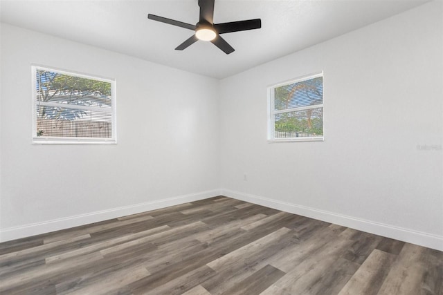 unfurnished room with ceiling fan and dark wood-type flooring