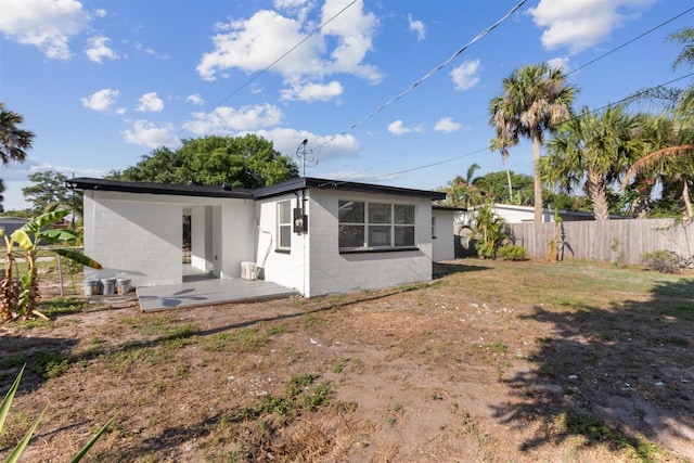 rear view of property with a yard