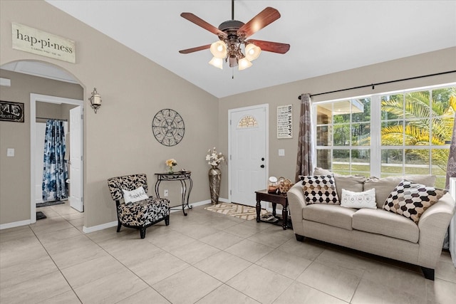 living room featuring lofted ceiling, ceiling fan, and light tile patterned floors