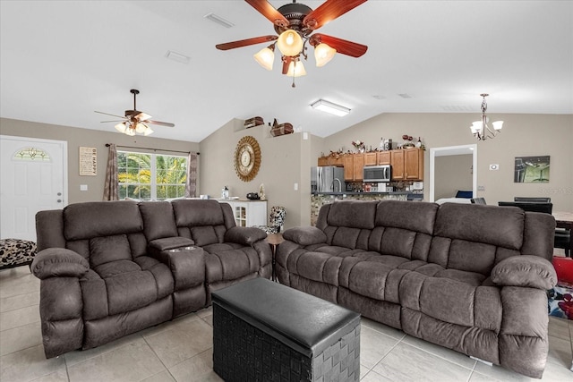 living room featuring vaulted ceiling, light tile patterned flooring, and ceiling fan with notable chandelier