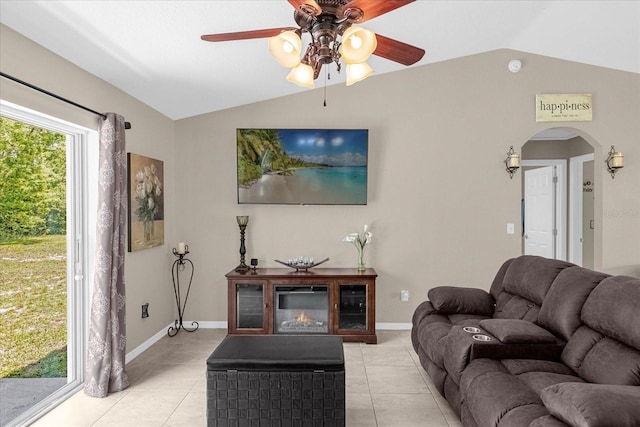 tiled living room featuring ceiling fan and vaulted ceiling