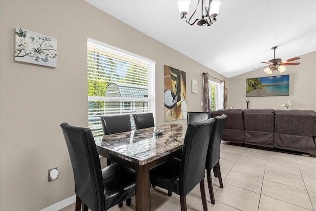 tiled dining area featuring lofted ceiling and ceiling fan with notable chandelier