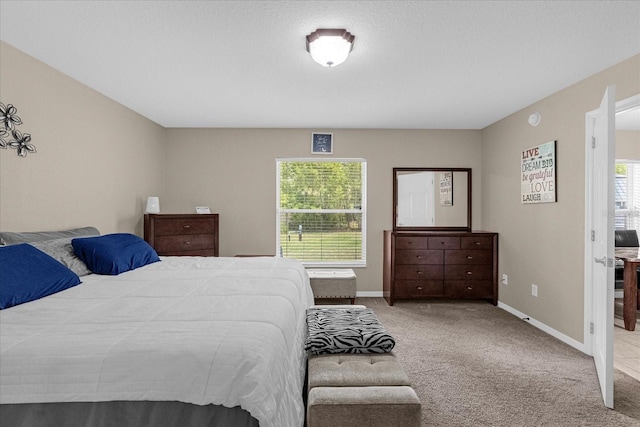 carpeted bedroom featuring multiple windows