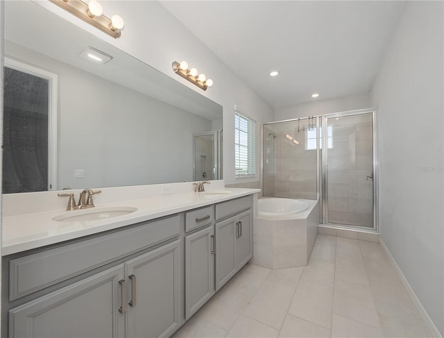 bathroom with tile patterned floors, vanity, and separate shower and tub