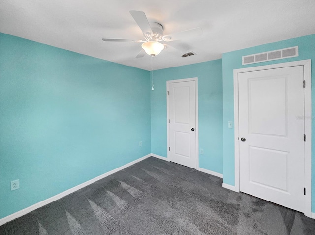 unfurnished bedroom featuring ceiling fan and dark colored carpet