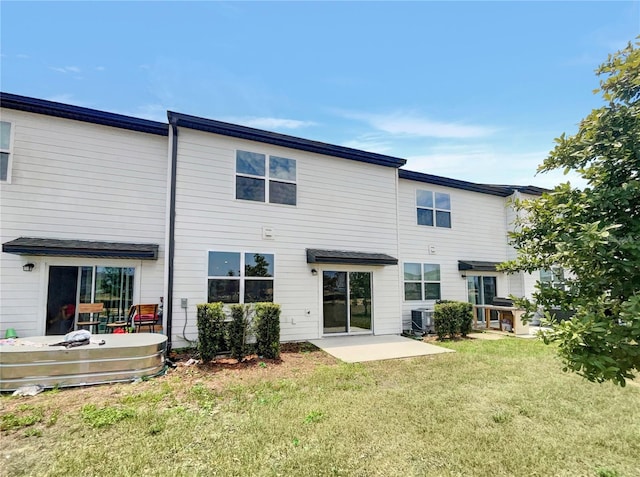 rear view of house featuring central AC, a yard, and a patio