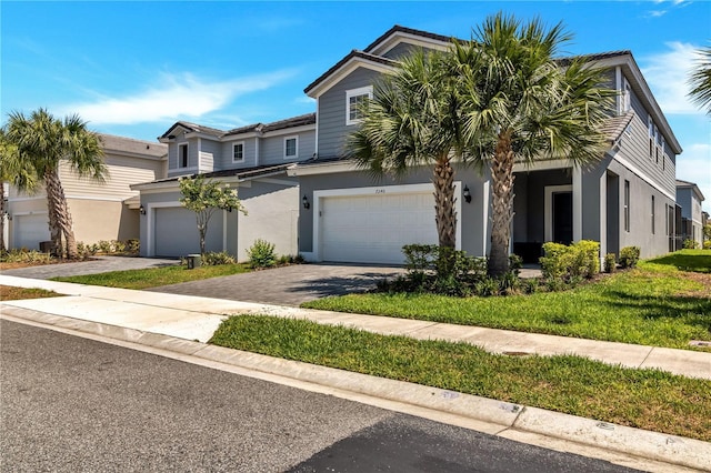 view of front of home featuring a garage and a front lawn