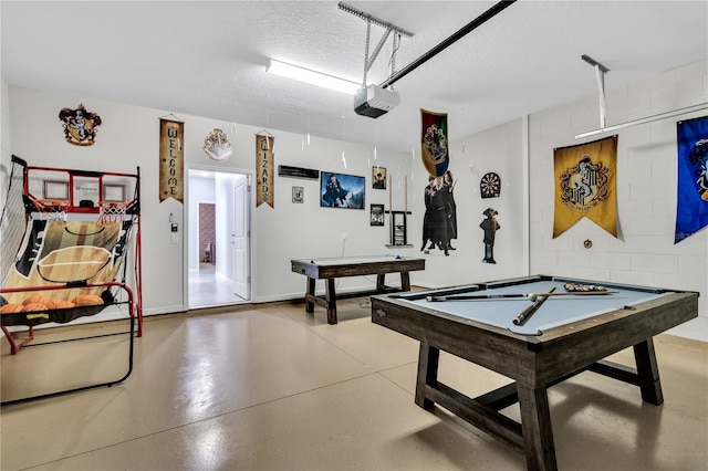 rec room with billiards, a textured ceiling, and concrete floors