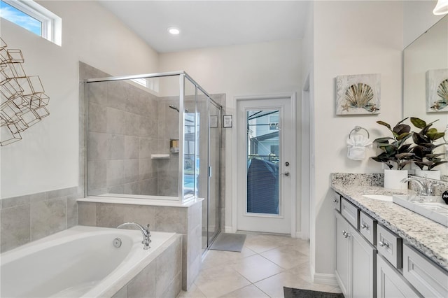 bathroom featuring shower with separate bathtub, tile patterned floors, and vanity