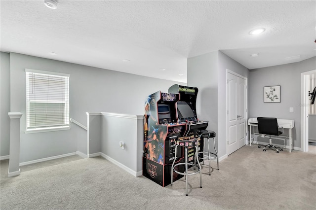 carpeted home office featuring a textured ceiling