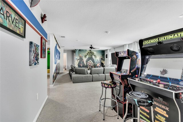 carpeted living room with ceiling fan and a textured ceiling