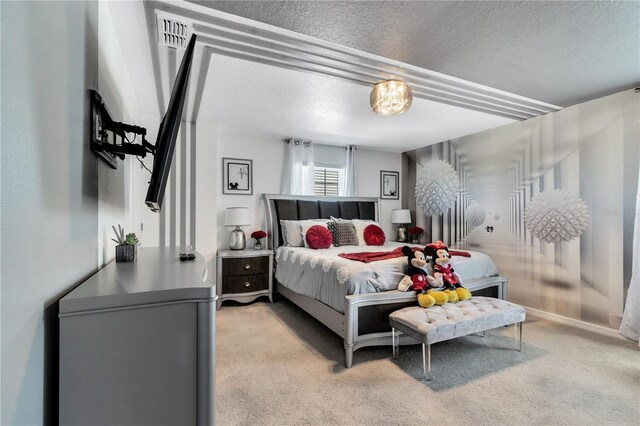 carpeted bedroom featuring a textured ceiling