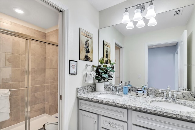 bathroom with an enclosed shower, vanity, and toilet