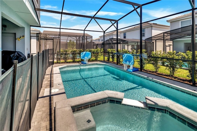 view of swimming pool with grilling area, glass enclosure, and an in ground hot tub