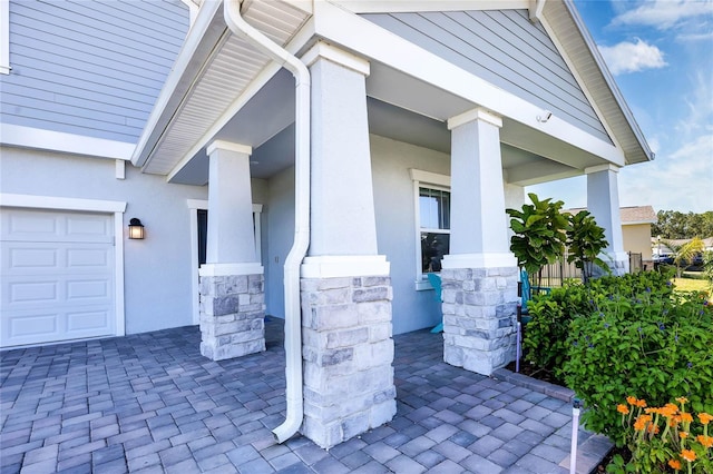 view of exterior entry with a garage