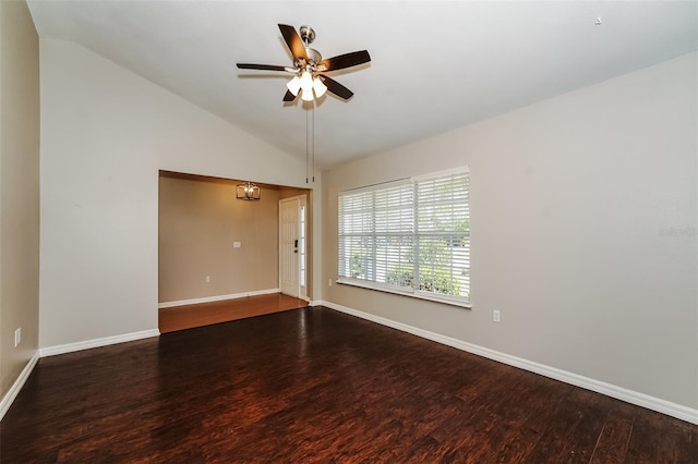 spare room with ceiling fan with notable chandelier, vaulted ceiling, and hardwood / wood-style flooring