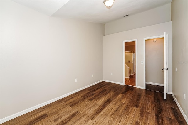 unfurnished bedroom featuring dark wood-type flooring