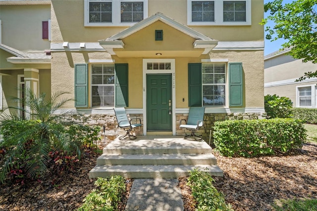 doorway to property with a porch