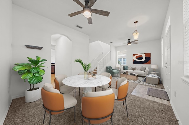 carpeted dining area featuring ceiling fan