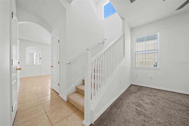 stairs featuring light carpet