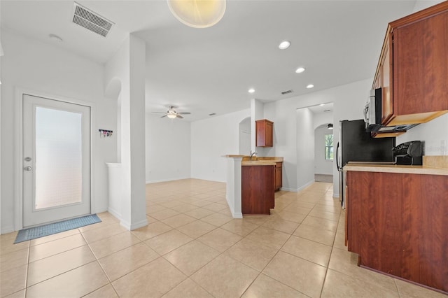 kitchen featuring sink, ceiling fan, and light tile floors