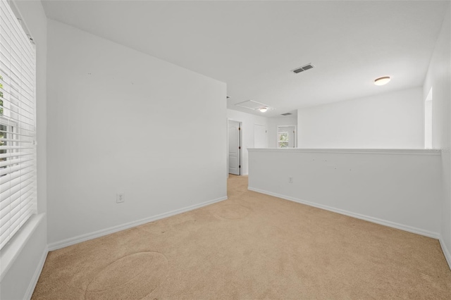 unfurnished room with light colored carpet