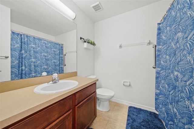 bathroom featuring vanity, toilet, and tile floors