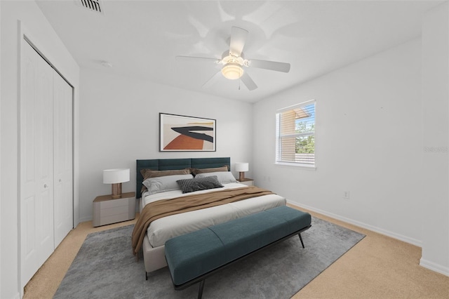 carpeted bedroom featuring a closet and ceiling fan