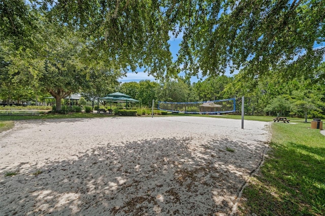 view of nearby features featuring a lawn and volleyball court