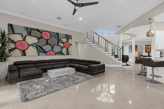 living room featuring ornate columns, crown molding, and ceiling fan