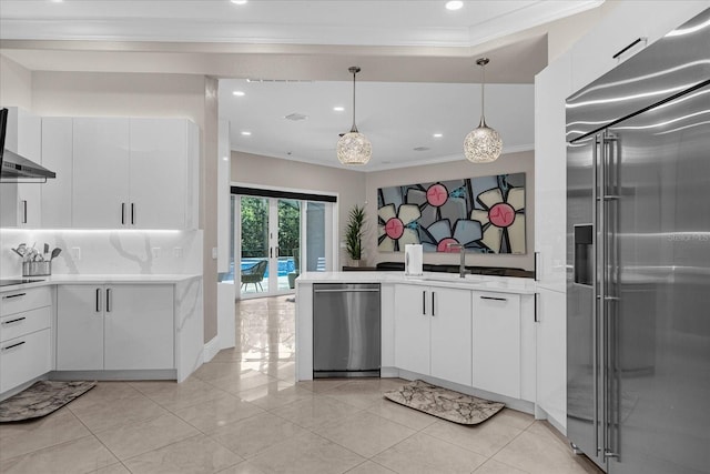 kitchen featuring white cabinetry, stainless steel appliances, sink, and hanging light fixtures