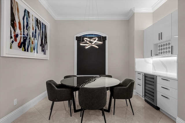 tiled dining space featuring wine cooler, crown molding, and a chandelier