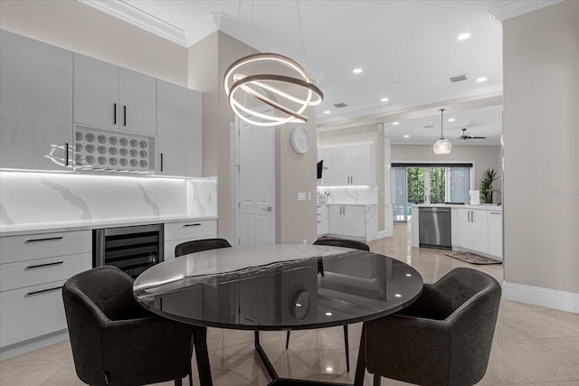 tiled dining room featuring a notable chandelier, crown molding, and beverage cooler