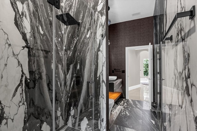 bathroom featuring a shower with shower door