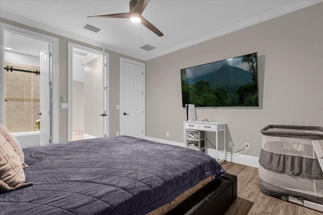 bedroom featuring wood-type flooring, ceiling fan, crown molding, and ensuite bath