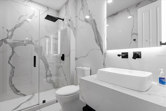 bathroom featuring sink, an enclosed shower, and toilet