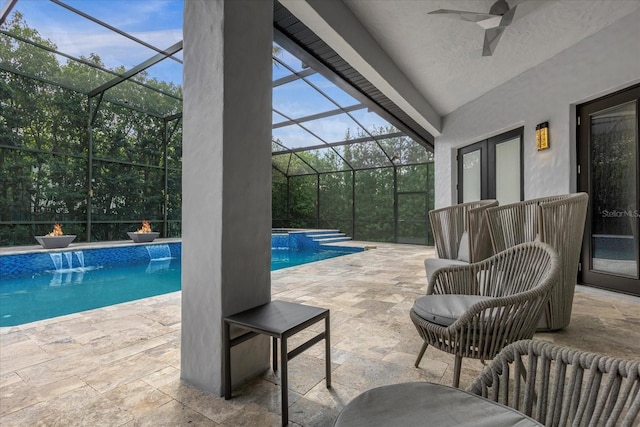 view of swimming pool with pool water feature, a patio area, and glass enclosure