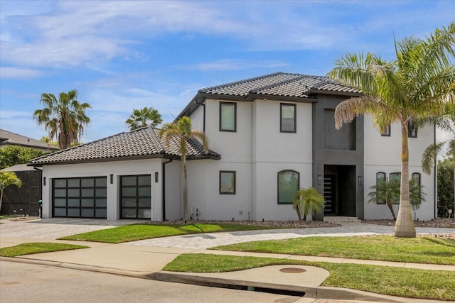 view of front of house featuring a garage and a front lawn