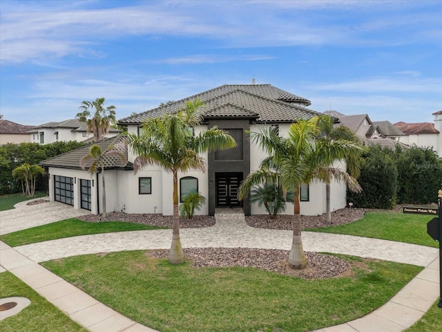 view of front of house with a garage and a front lawn